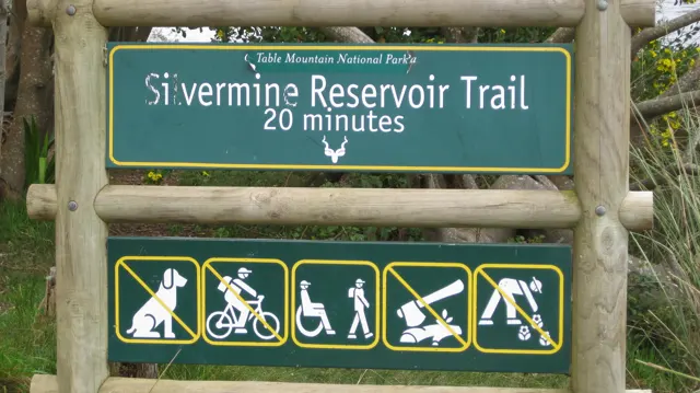 A wooden-framed sign marks the Silvermine Reservoir Trail and a twenty-minute route.