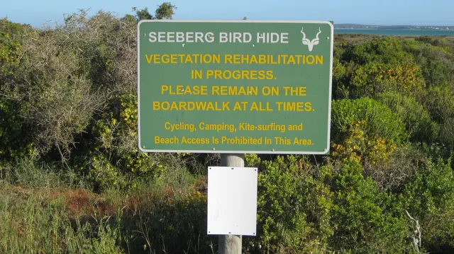 A Seeberg Bird Hide sign asks visitors to remain on the boardwalk.