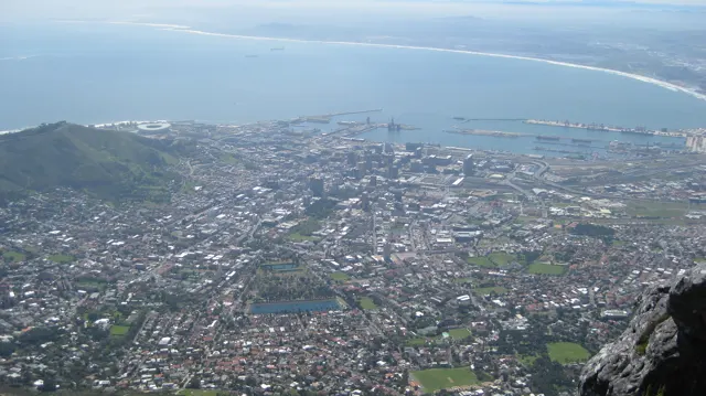 Dense city blocks fill the view beneath a broad bay.