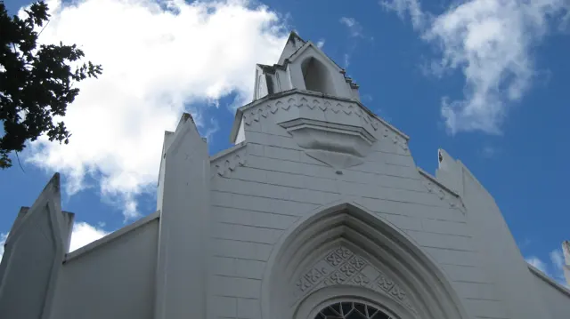A pointed white facade rises above an arched entrance.