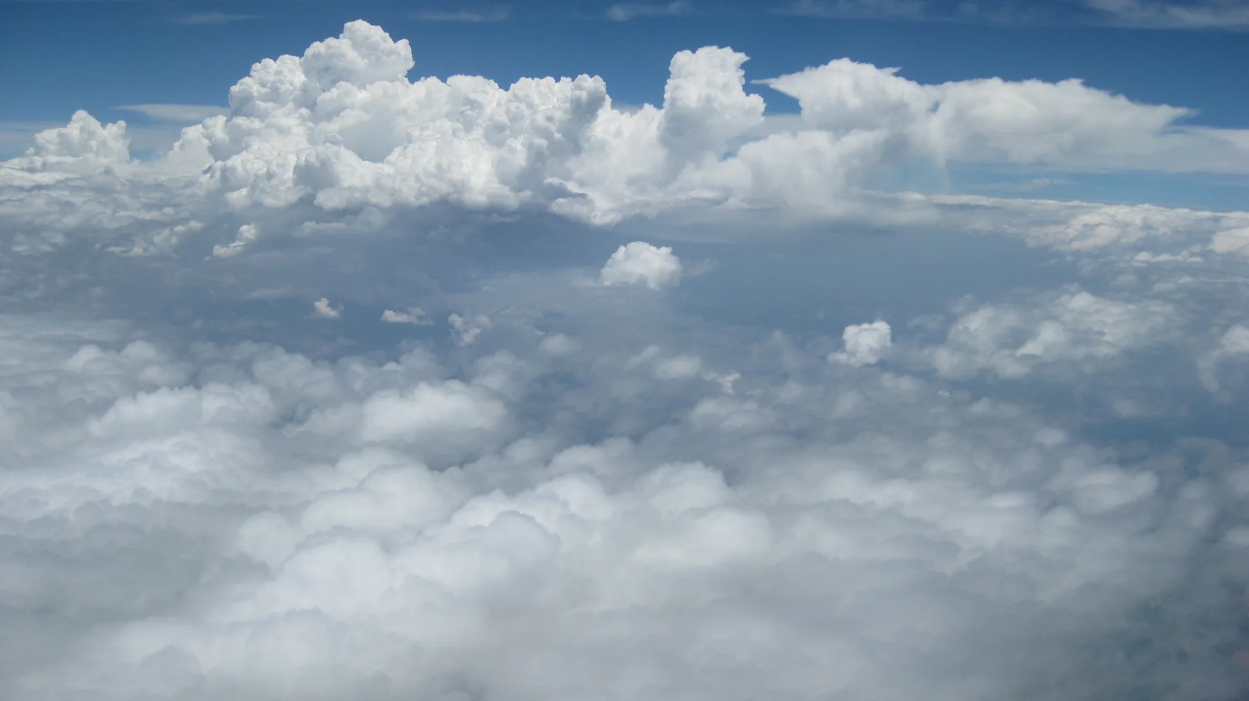 White cloud peaks rise above a softer lower blanket.