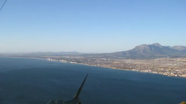 A developed coastline stretches beside deep blue water.