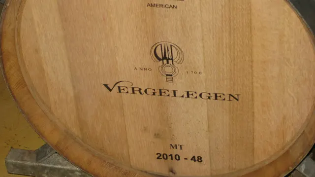 The Vergelegen name is branded onto a wooden barrel face.