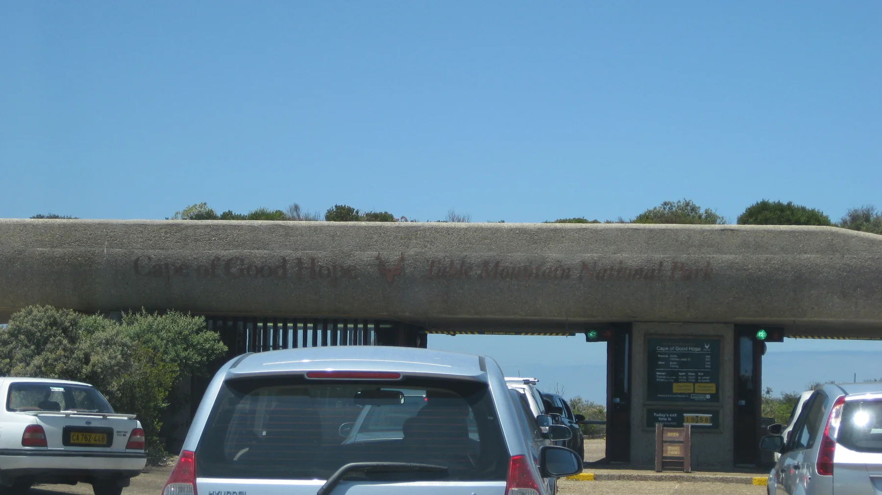 Cars queue beneath a broad entrance canopy.