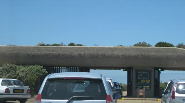 Cars queue beneath a broad entrance canopy.
