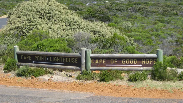 Wooden direction boards point toward Cape Point and Cape of Good Hope.