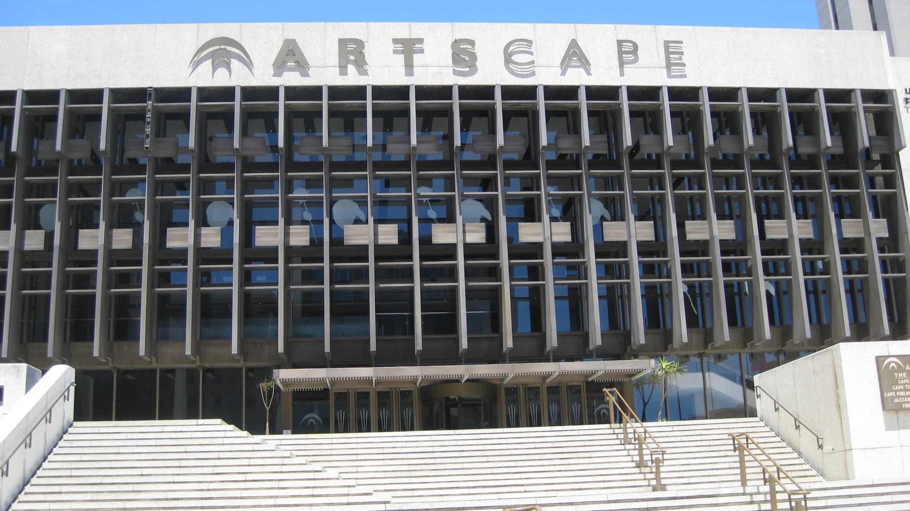 Broad steps rise toward the gridded Artscape facade.