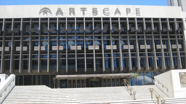 Broad steps rise toward the gridded Artscape facade.