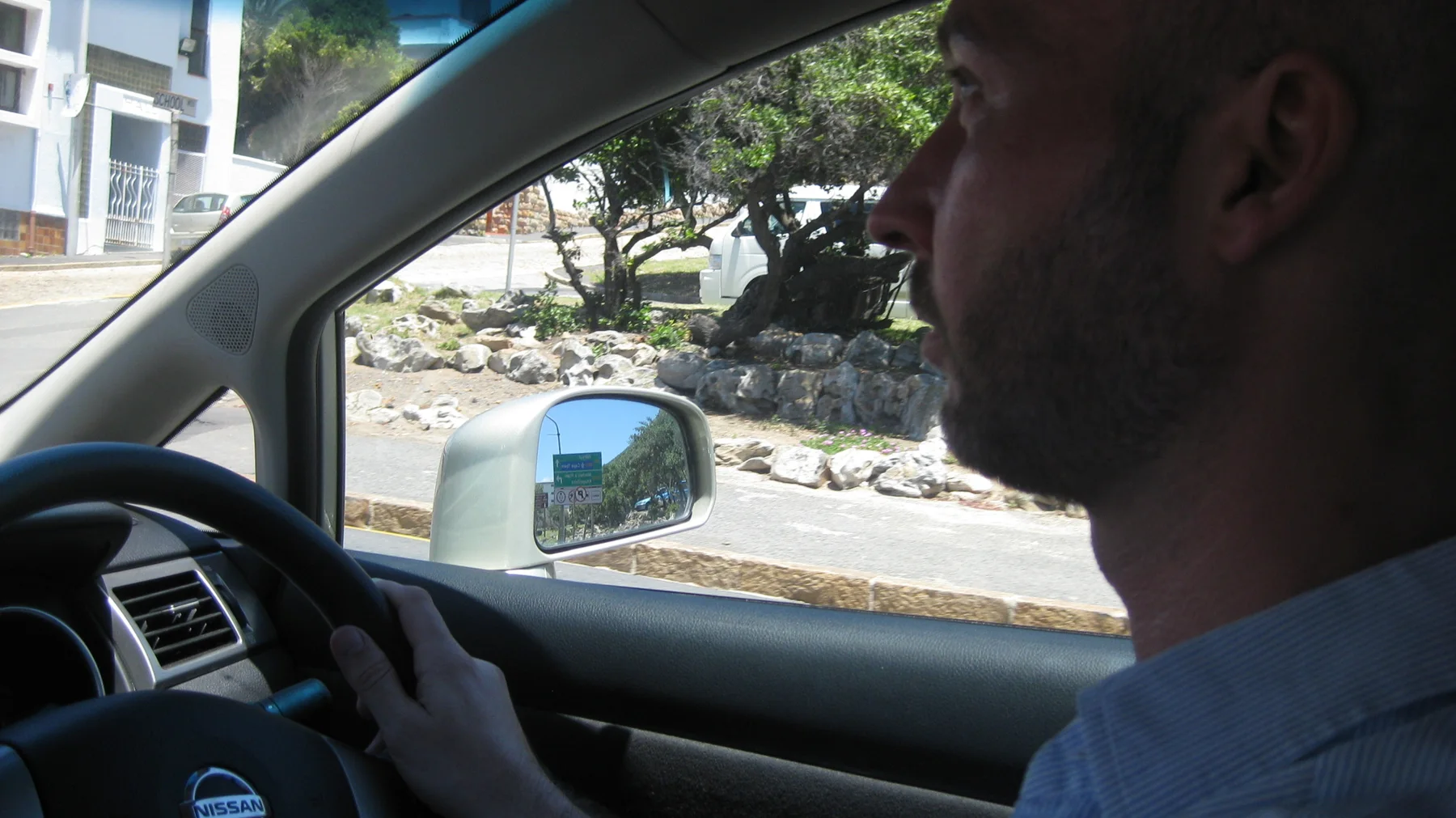 A driver is seen in profile inside a car during the journey.